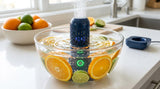 Limpiador ultrasonico limpiando naranjas y limones en un bowl